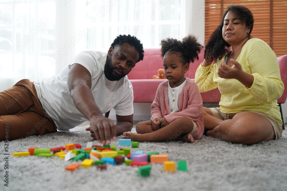 Shot of happy interracial family of mother father and their daughter inside modern apartment. Shot of happy interracial family of mother father and their daughter inside modern apartment.