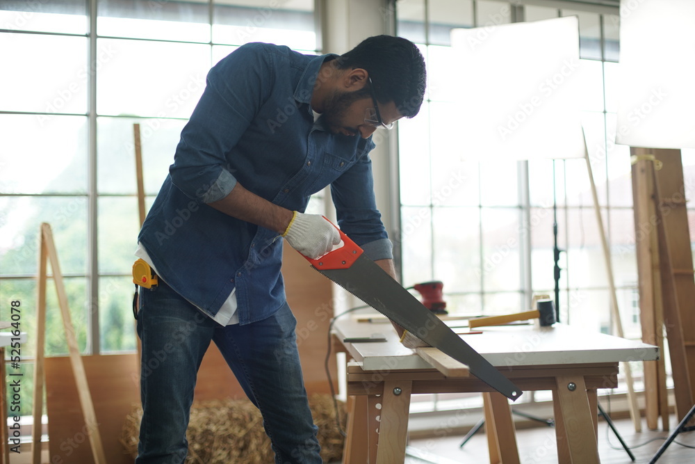 Carpenter or warehouse worker choosing raw wood material for the work at the carpentry storage