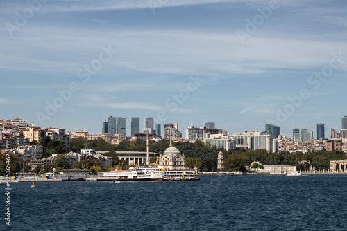 View of ferry boats, historical mosque and European side of Istanbul. It is a sunny summer day. © theendup