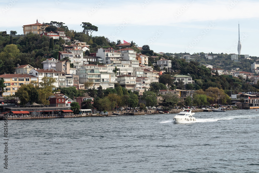 View of a yacht on Bosphorus and Cengelkoy area of Asian side in Istanbul.