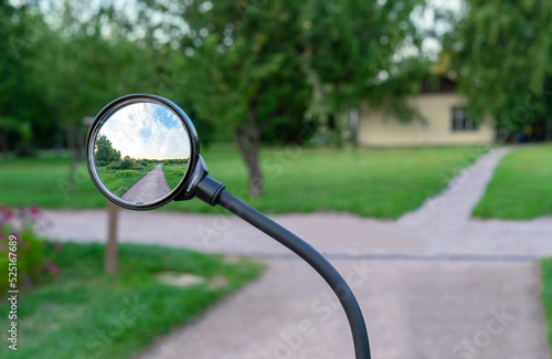 Bicycle rear view mirror with nature reflection.