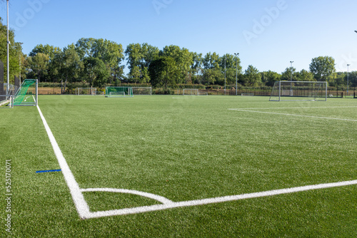 Football field with artificial turf and white markings for practice.