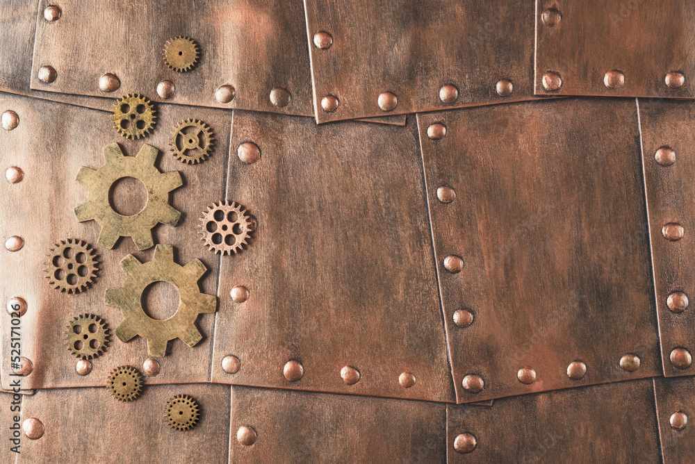 Gears on copper metallic plates with copy space. Steampunk background