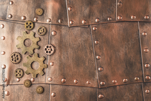 Gears on copper metallic plates with copy space. Steampunk background