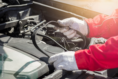 Fotografia Car timing belt in the hands of an auto mechanic
