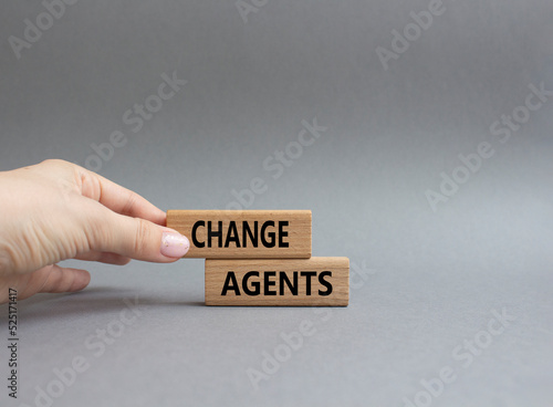 Change agents symbol. Concept word Change agents on wooden blocks. Beautiful grey background. Businessman hand. Business and Change agents concept. Copy space