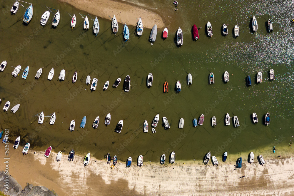 Aerial view of boats in a dry harbour at low tide (New Quay, Wales)