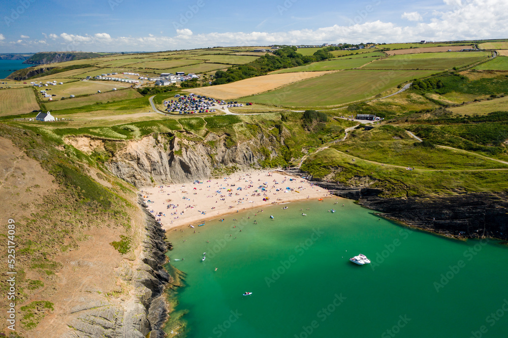 Aerial view of a busy beach and bay in West Wales (Mwnt, Ceredigion)