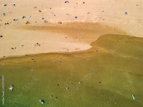 Top down aerial view of people on a busy sandy beach (Broad Haven South, Wales) photo