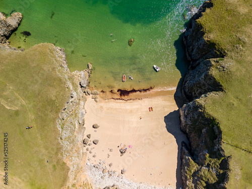 Top down aerial view of a tiny sandy beach and cove in West Wales (Pembrokeshire) photo