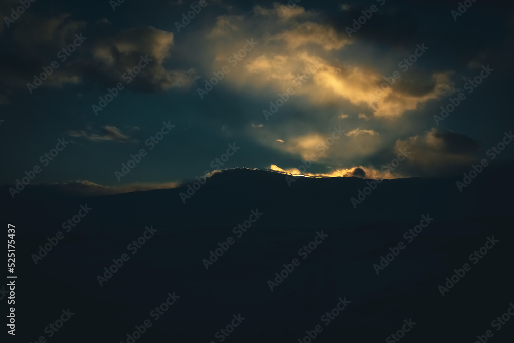 Obraz premium Sunset cloudy sky with the orange sun