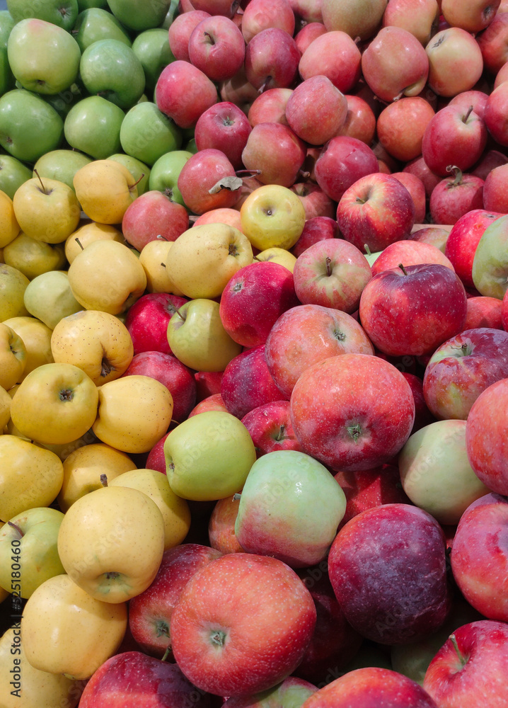 Fresh red yellow and green apples of different varieties on the market counter Fresh red yellow and green apples of different varieties on the market counter