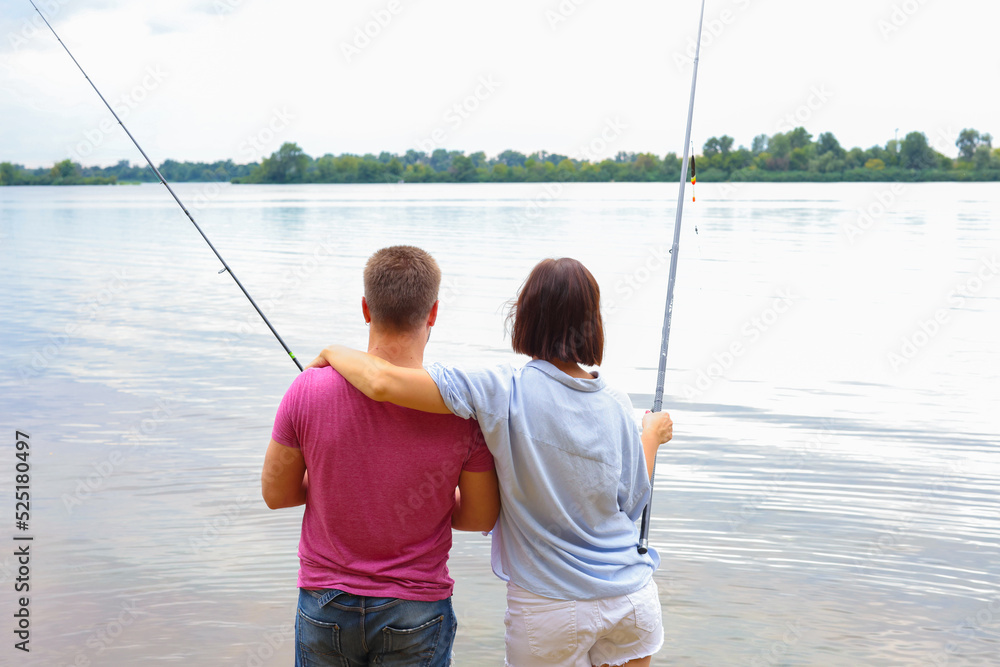 couple fishing together on the river. man and woman fishing resting in nature couple fishing together on the river. man and woman fishing resting in nature