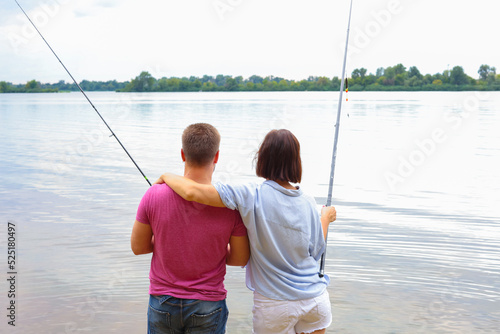 couple fishing together on the river. man and woman fishing resting in nature