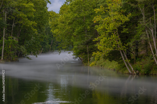 Summertime fog hangs lightly over the South Holston River, Tennessee