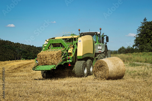 a straw harvesting machine on a grain field