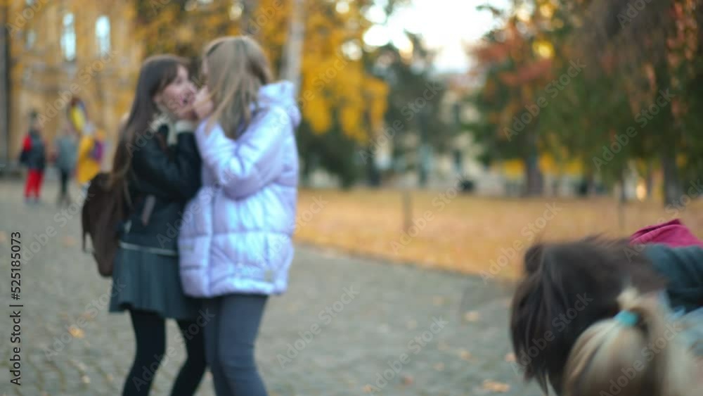 Boy and girl fighting on schoolyard with shocked classmates standing at background. Angry unsatisfied Caucasian teens pushing each other outdoors. Misunderstanding and conflicts concept Boy and girl fighting on schoolyard with shocked classmates standing at background. Angry unsatisfied Caucasian teens pushing each other outdoors. Misunderstanding and conflicts concept