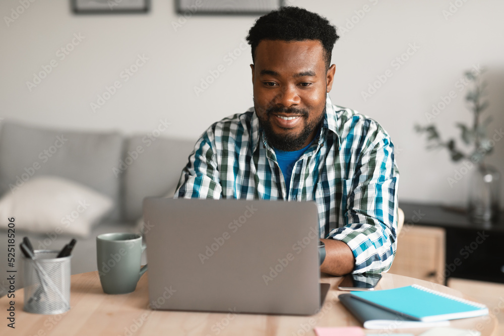 African American Entrepreneur Man Using Laptop Working Online At Home African American Entrepreneur Man Using Laptop Working Online At Home