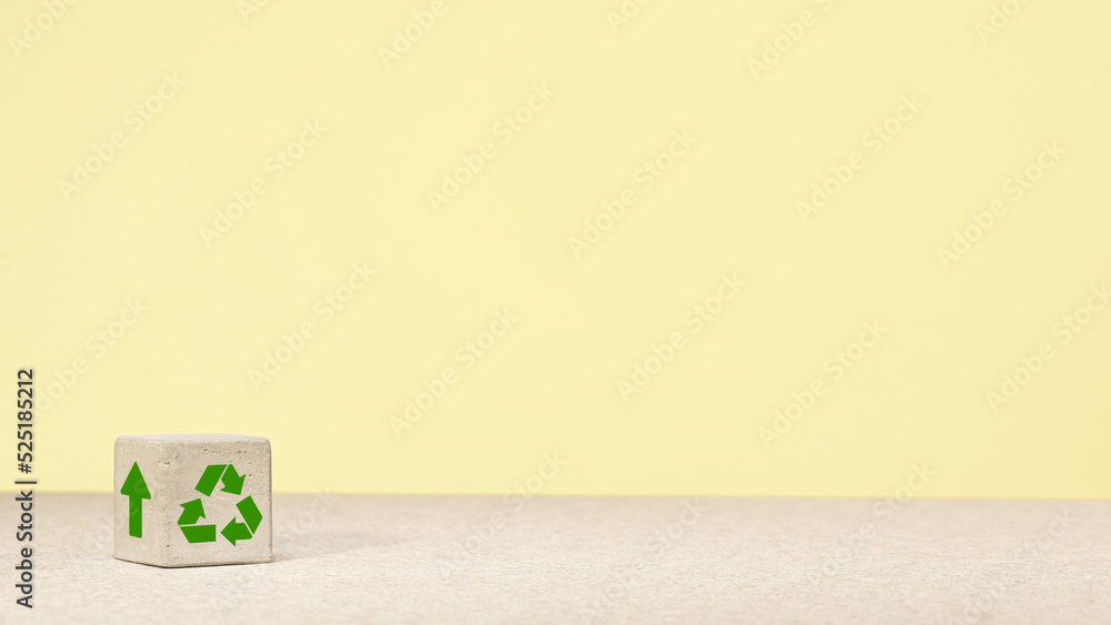 The concept of environmental protection. concrete cube with green economy icons, energy sources. copy space. green energy