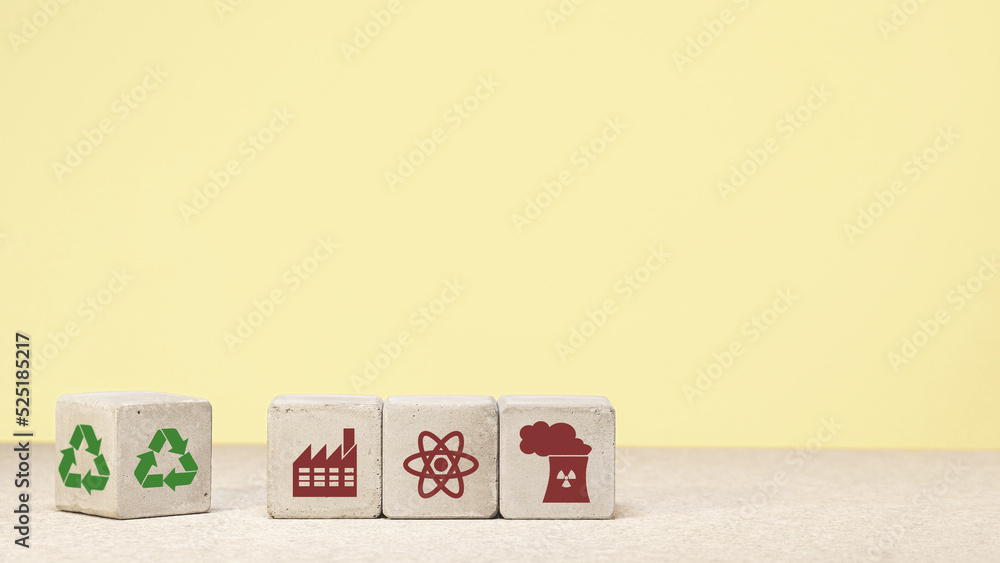 The concept of environmental protection. concrete cube with green economy icons, energy sources. copy space. green energy The concept of environmental protection. concrete cube with green economy icons, energy sources. copy space. green energy