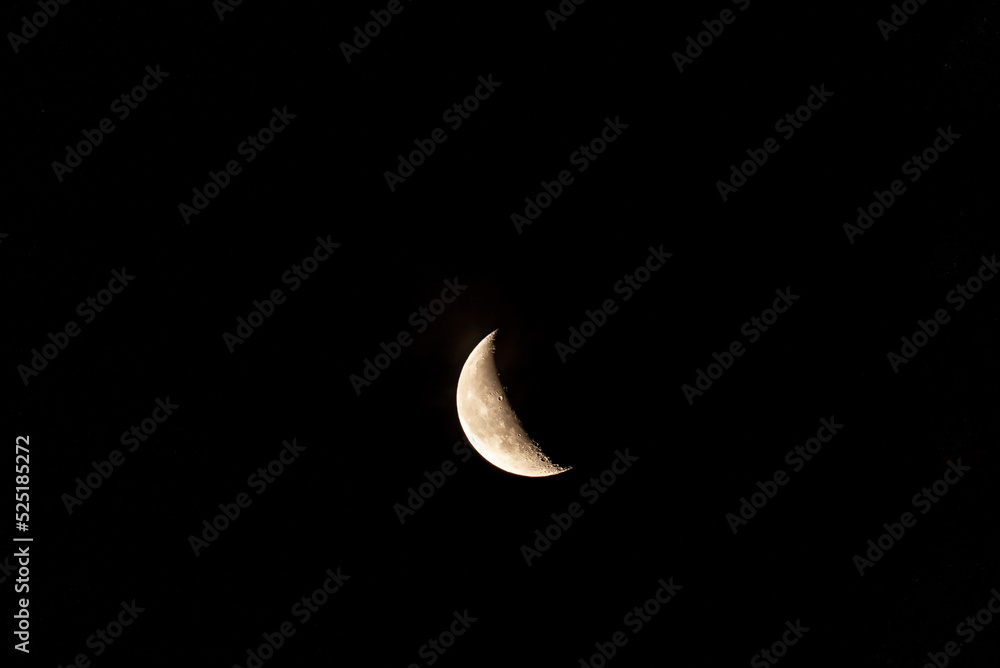 Beautiful orange quarter moon in the dark night sky over Riga city. Beautiful orange quarter moon in the dark night sky over Riga city.