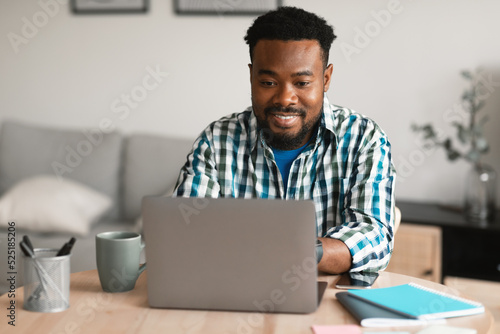 African American Entrepreneur Man Using Laptop Working Online At Home