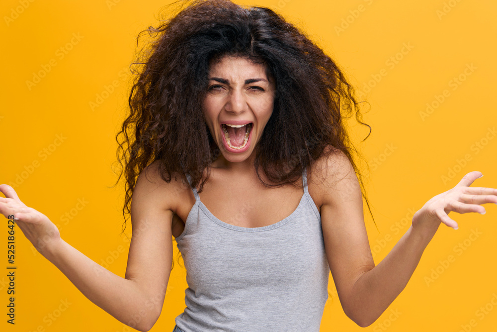 COOL OFFER. Irritated emotional pretty Latin female with afro scream to camera, hold hands up, gesture Bid Fail, stay isolated over yellow background. Conflict concept. Copy space, free place COOL OFFER. Irritated emotional pretty Latin female with afro scream to camera, hold hands up, gesture Bid Fail, stay isolated over yellow background. Conflict concept. Copy space, free place