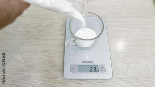 pour sugar into a clear glass tumbler and weighs 160 grams on a kitchen scale