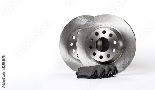 New brake discs and pads stand on a white background. copyspace. photo
