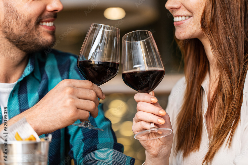 leisure, drinks and people concept - close up of happy couple drinking red wine at restaurant leisure, drinks and people concept - close up of happy couple drinking red wine at restaurant