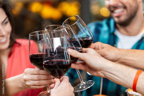 Photography leisure, people and celebration concept - close up of happy friends drinking red