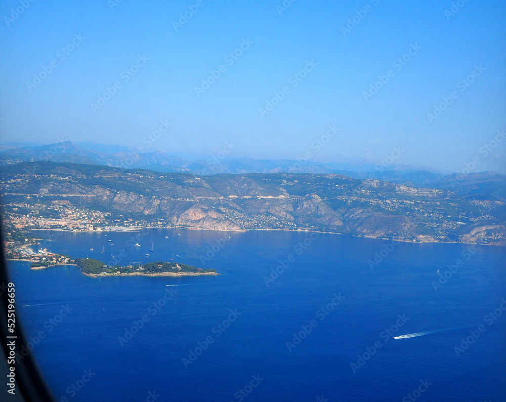 view from the airplane window on the Mediterranean Sea, the mountains of the Alps, French Riviera, Cote d'Azur, Nice, France