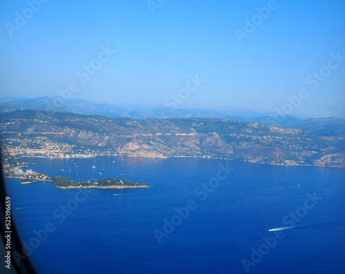view from the airplane window on the Mediterranean Sea, the mountains of the Alps, French Riviera, Cote d'Azur, Nice, France © elens19