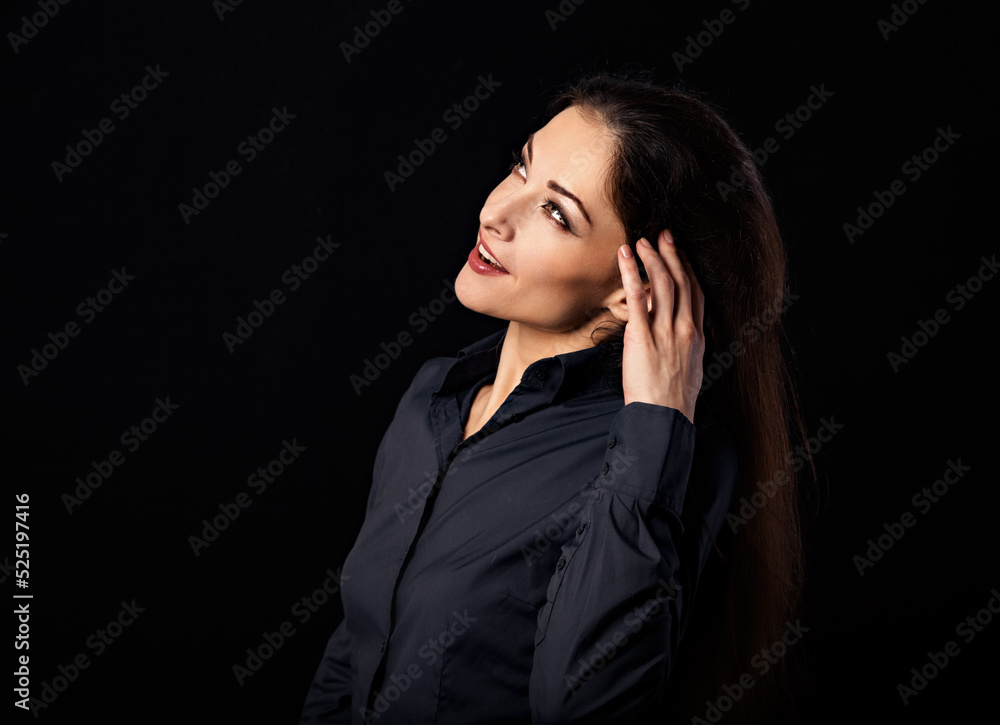 Beautiful thinking serious business woman looking up and scratching her head in blue shirt on black background with empty copy space for text. Closeup Beautiful thinking serious business woman looking up and scratching her head in blue shirt on black background with empty copy space for text. Closeup
