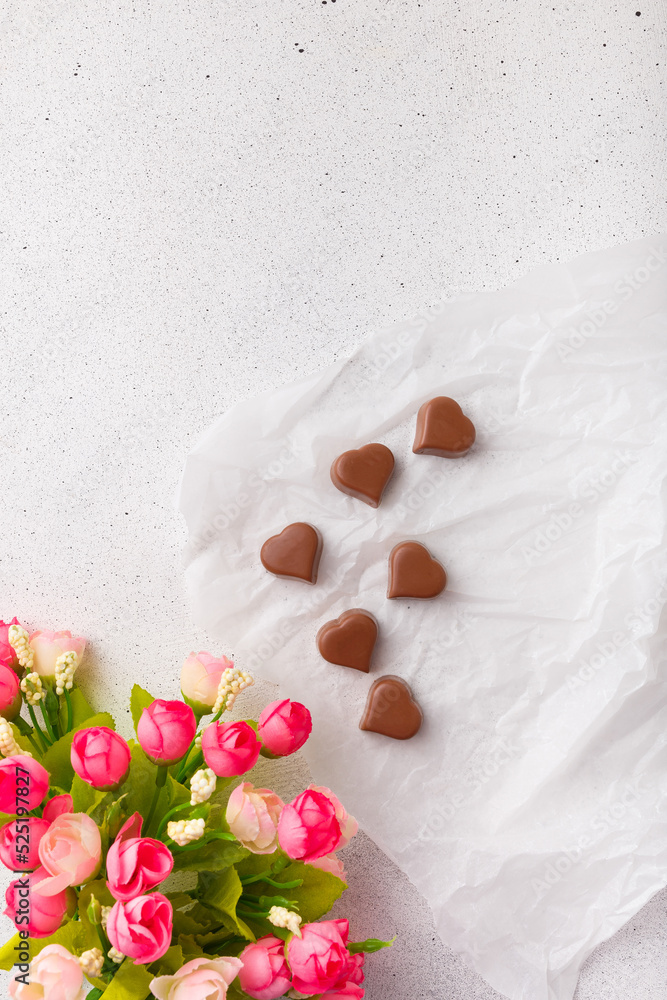 14 February Heart shaped chocolates, bright flowers on white paper. Valentines day sweets 14 February Heart shaped chocolates, bright flowers on white paper. Valentines day sweets