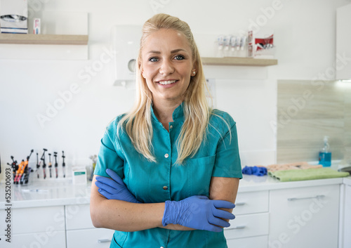 Portrait of a female dentist. She s standing in her dentist office.