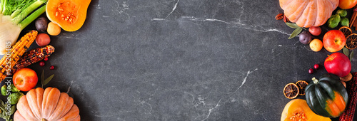 Panel kuchenny z motywem Autumn food double border with pumpkins, apples, squash and a variety of vegetables. Overhead view on a dark stone banner background with copy space.