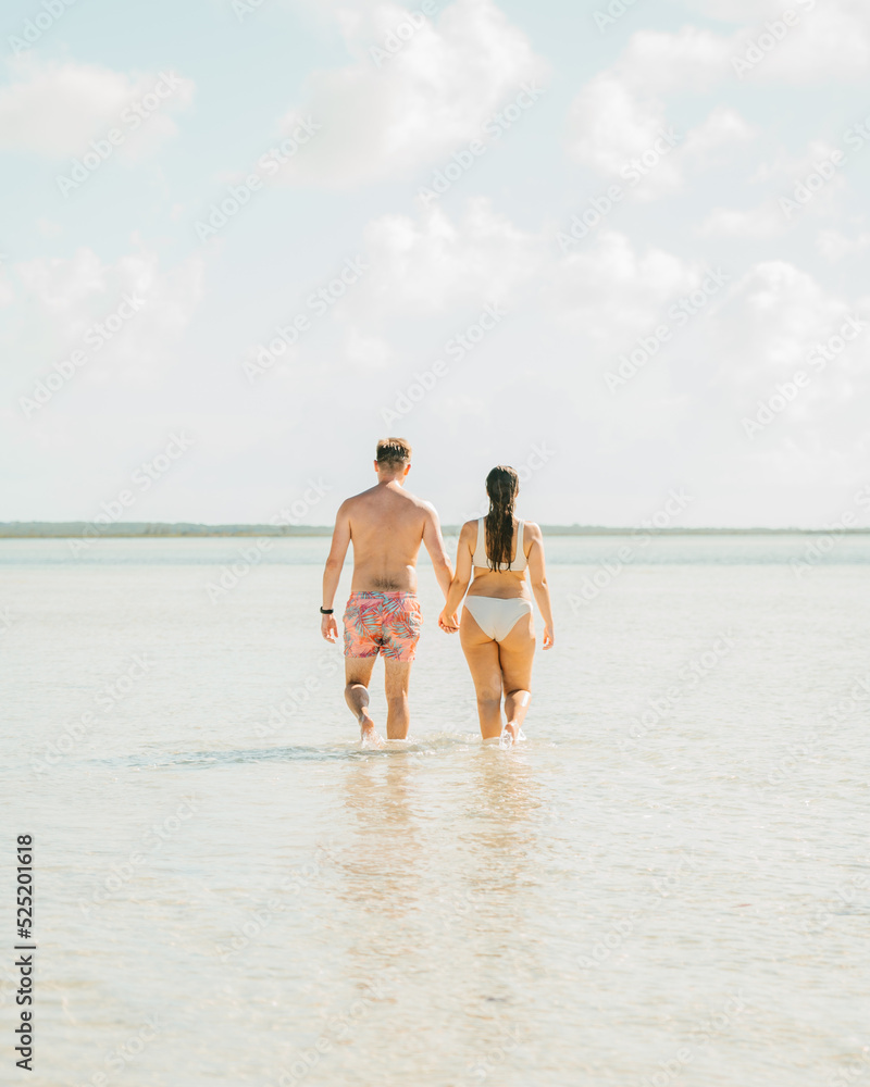 Couple walking on the beach. Exuma, Bahamas