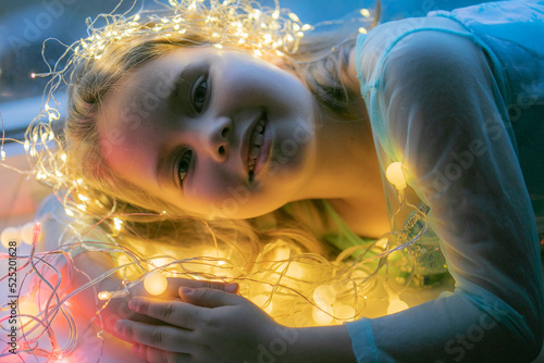 Cheerful small girl indoors at home at Christmas