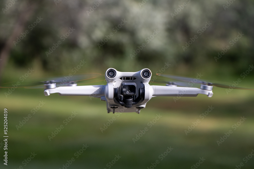 Close up drone with camera sensors and props flying in air with nature  behind - DJI Mini 3 Pro aerial uav foto de Stock | Adobe Stock