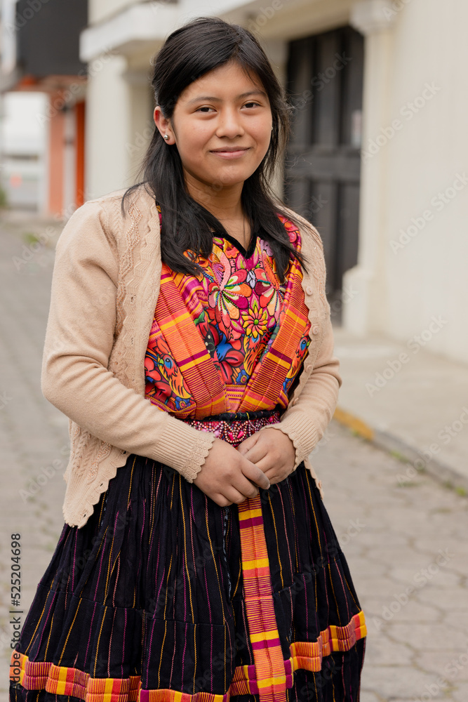 Young woman with her typical Mayan costume smiling at the camera - Happy Hispanic young woman in the village in Latin America