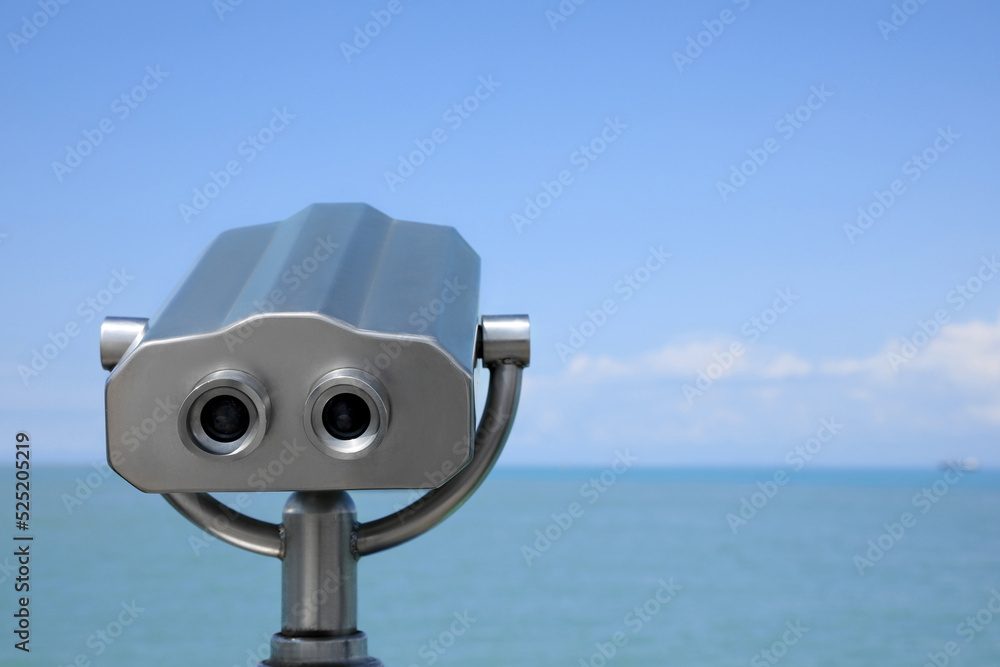 Metal tower viewer installed near sea, space for text. Mounted binoculars Metal tower viewer installed near sea, space for text. Mounted binoculars