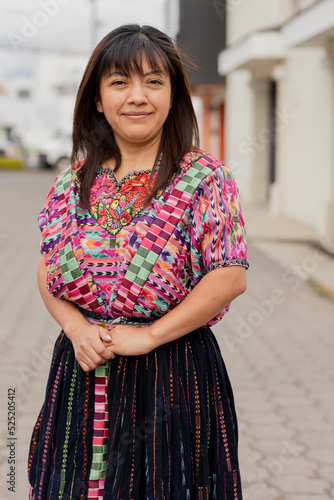 Young Mayan woman smiling at the camera - Portrait of a happy young Hispanic woman in her city in Latin America © Fernanda