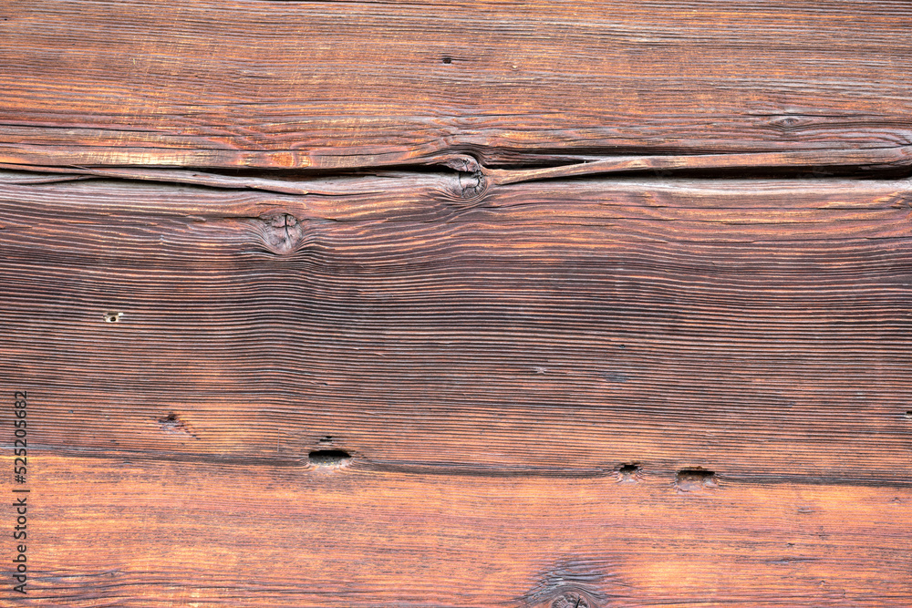 Naklejka premium Old and weathered dark brown cracked wood beam surface with nice rough grain texture.