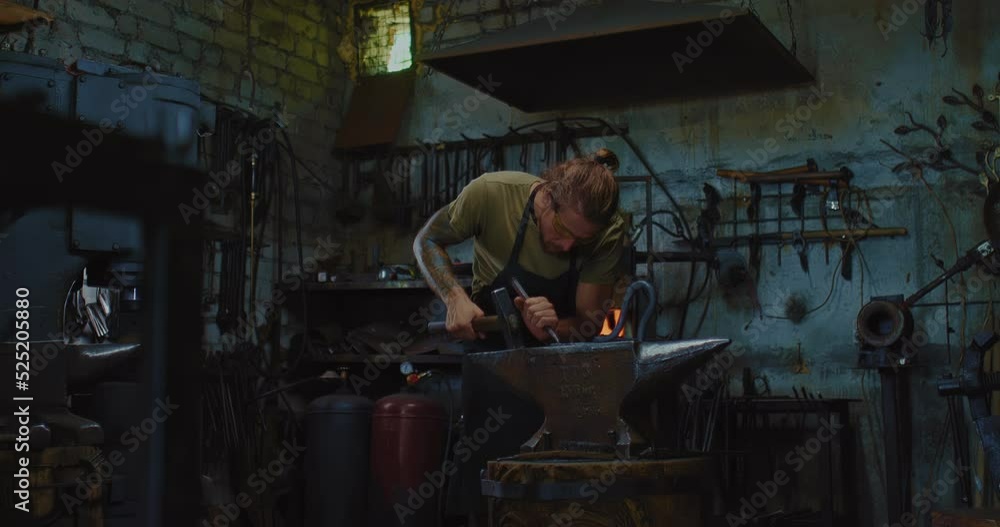 handsome blacksmith is working in traditional forge with modern equipment, 4K, Prores handsome blacksmith is working in traditional forge with modern equipment, 4K, Prores