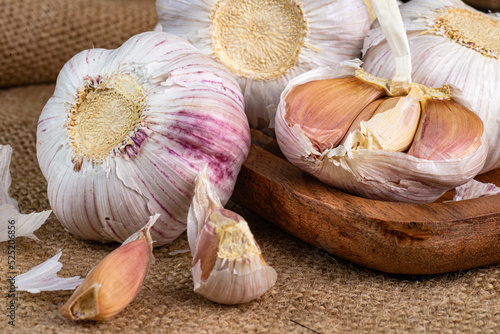 Slices and Whole bulb of garlic close up. Selective forus. photo