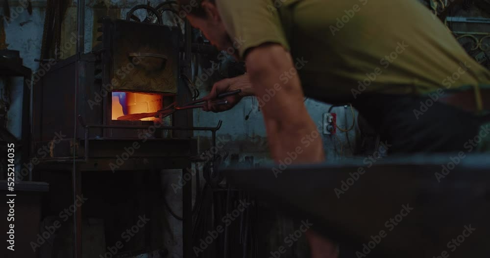 craftsman is putting workpiece in hot furnace, smith is working alone in forge, 4K, Prores craftsman is putting workpiece in hot furnace, smith is working alone in forge, 4K, Prores