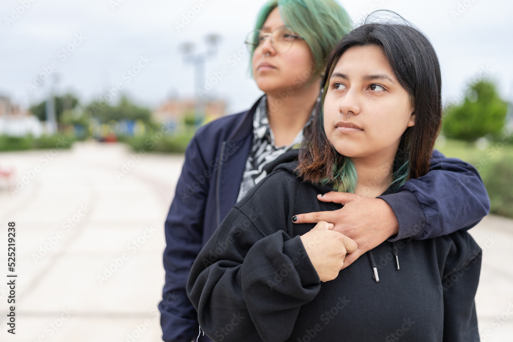 Lesbian couple embraced in the street Lesbian couple embraced in the street
