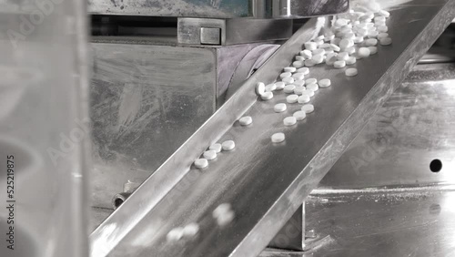Automatic work cycle of a modern Pill Press Machine rotary tablet - Pharmaceutical factory. Medication production process,The machine vibrates and the pills slide on the rail