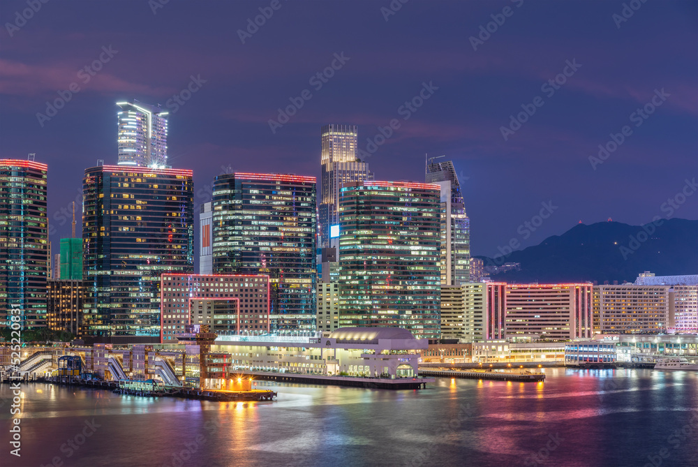 High rise office building and pier in Hong Kong city at dusk